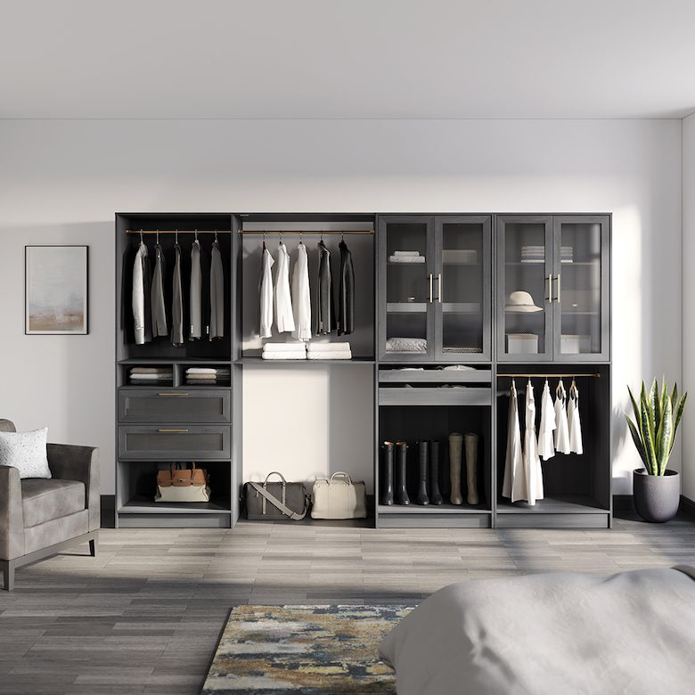 Spacious wardrobe with black cabinets, glass doors, and organized clothing storage in a modern room