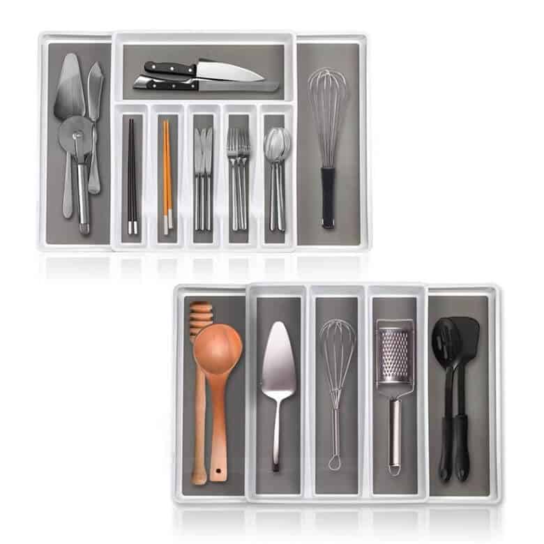 Drawer organizers with assorted kitchen utensils, knives, and flatware neatly arranged