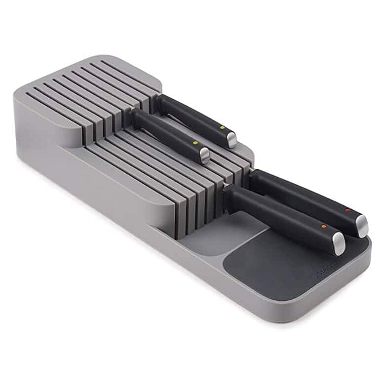 Compact in-drawer knife organizer with black-handled knives neatly stored in horizontal slots