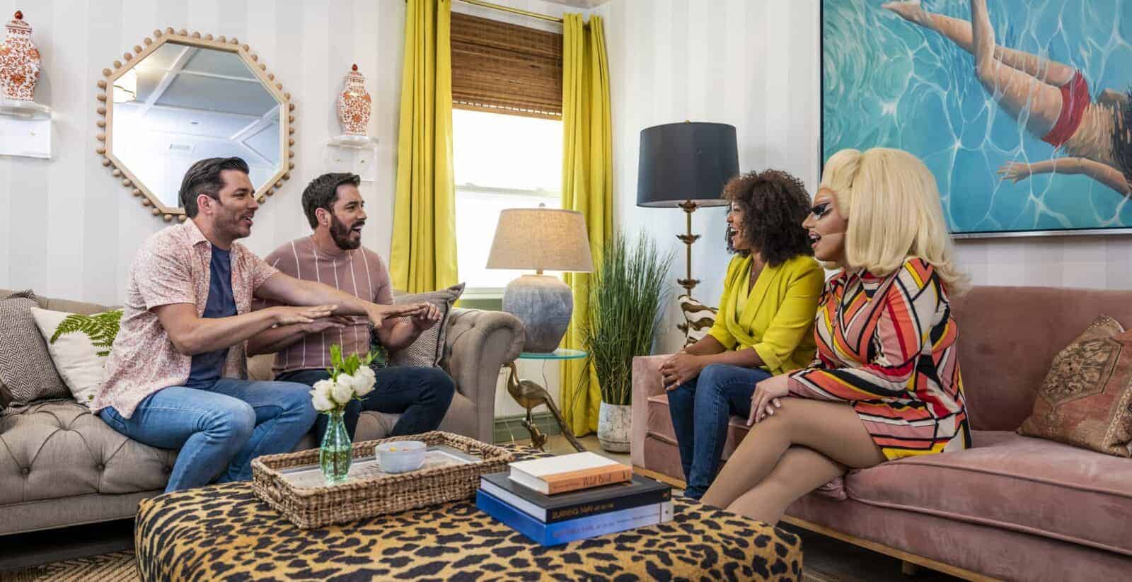 Drew and Jonathan Scott chatting with two guests in a colorful living room