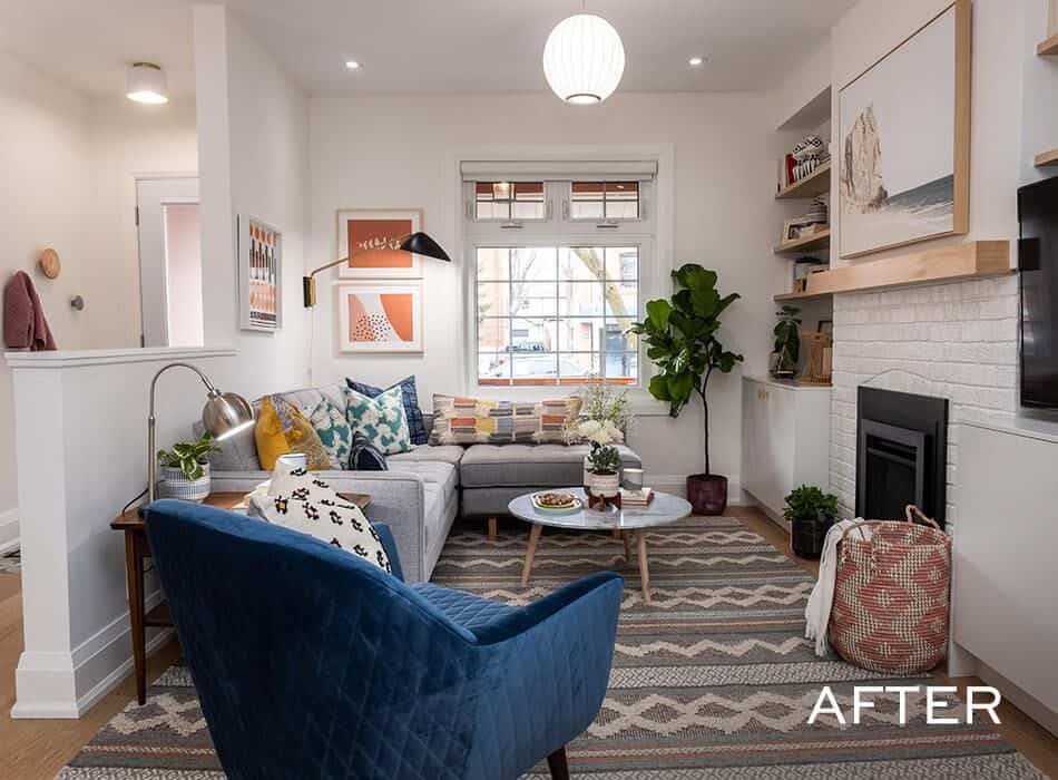 Bright modern living room with gray sectional, blue accent chair, indoor plants, and a white brick fireplace