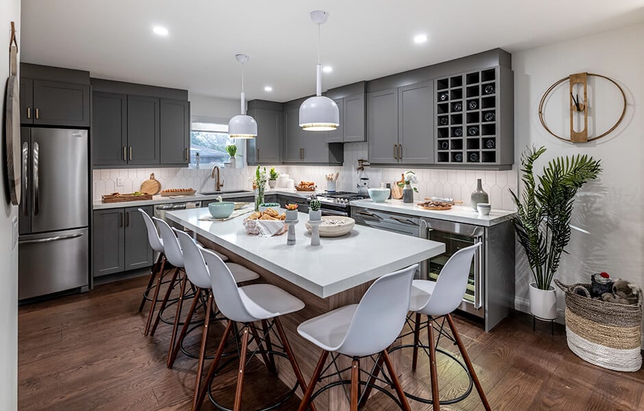Contemporary kitchen with gray cabinets, white countertops, and pendant lighting