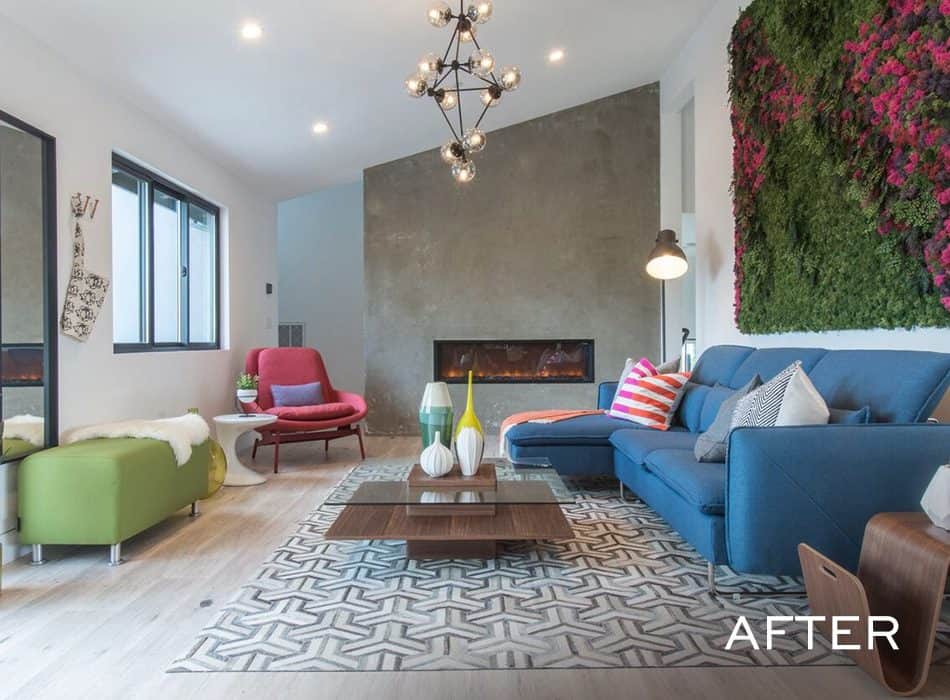 Modern living room with blue sofa, green wall art, geometric rug, and contemporary lighting