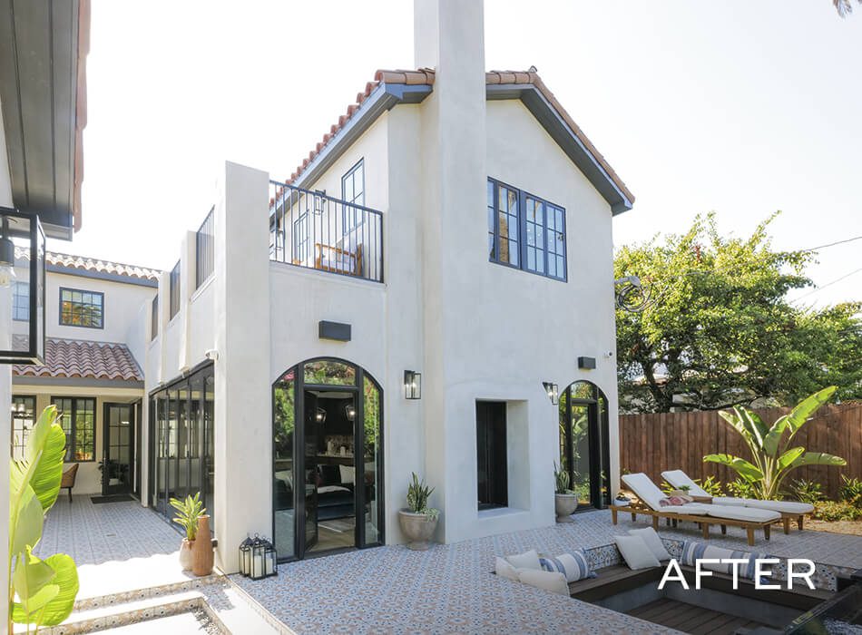 Renovated Mediterranean-style courtyard with tiled flooring, arched glass doors, and outdoor seating