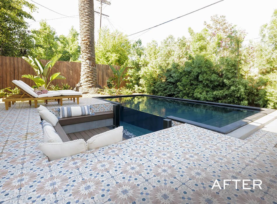 Tiled patio with built-in sunken seating beside a rectangular pool and lounge chairs