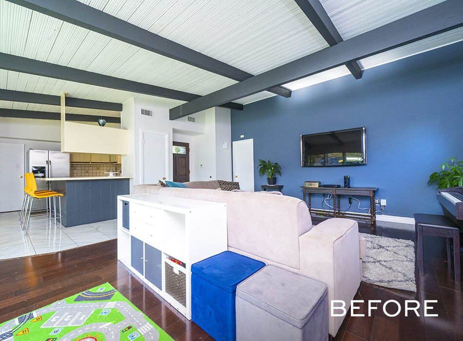 Living room with blue accent wall, TV, and sectional sofa