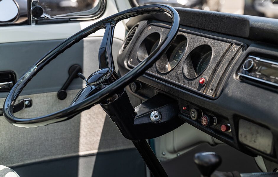 Interior view of a vintage Volkswagen van showing the steering wheel and dashboard