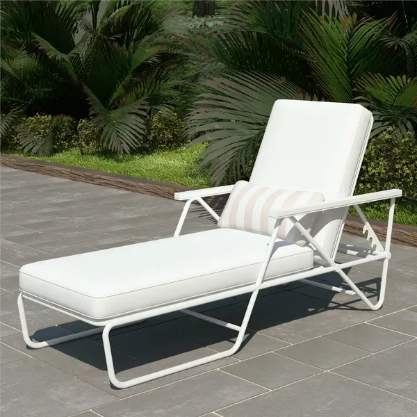 White cushioned outdoor chaise lounge with metal frame and striped pillow