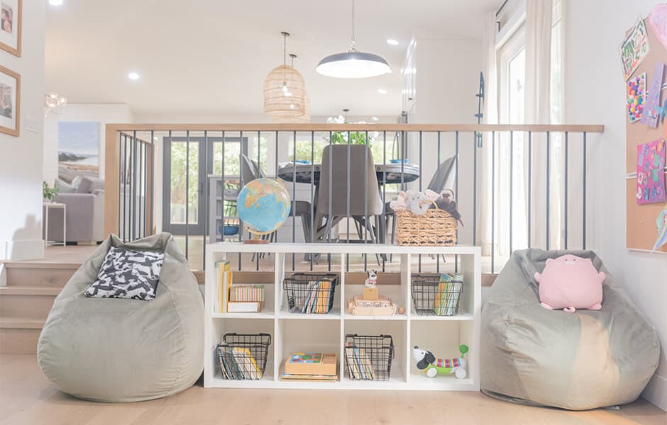 Playroom area with cubby shelves, storage baskets, bean bag chairs, and a globe
