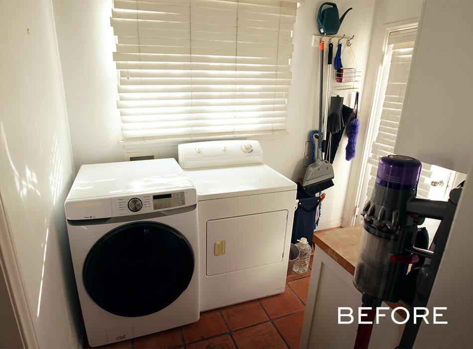 Laundry room with washer, dryer, wall-mounted cleaning tools, and cordless vacuum