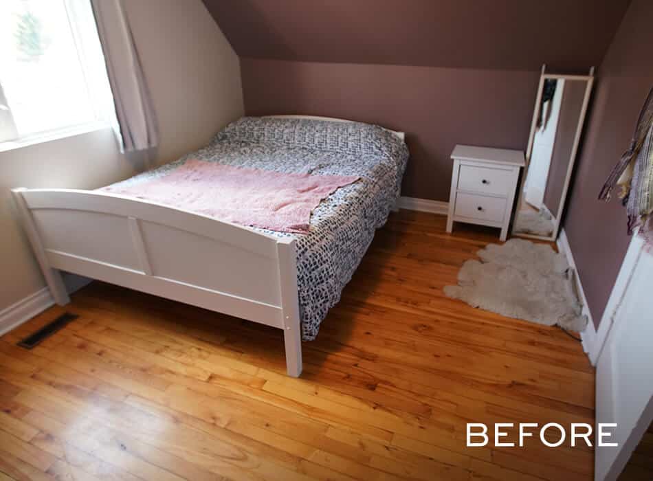 Small bedroom with a white bed, patterned bedding, single nightstand, floor mirror, and wooden floors