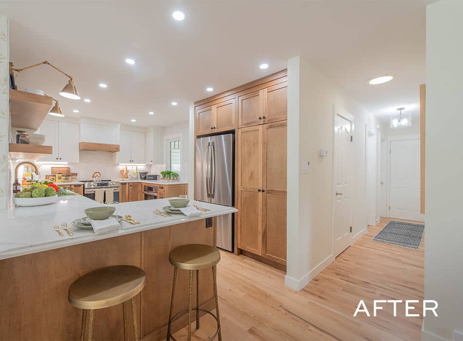 Bright kitchen with wood cabinets, white counters, stainless appliances, and bar seating