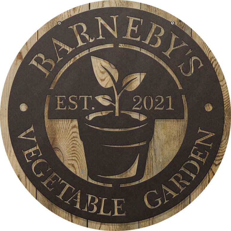 Wooden garden sign with plant graphic reading "Barneby's Vegetable Garden Est. 2021."