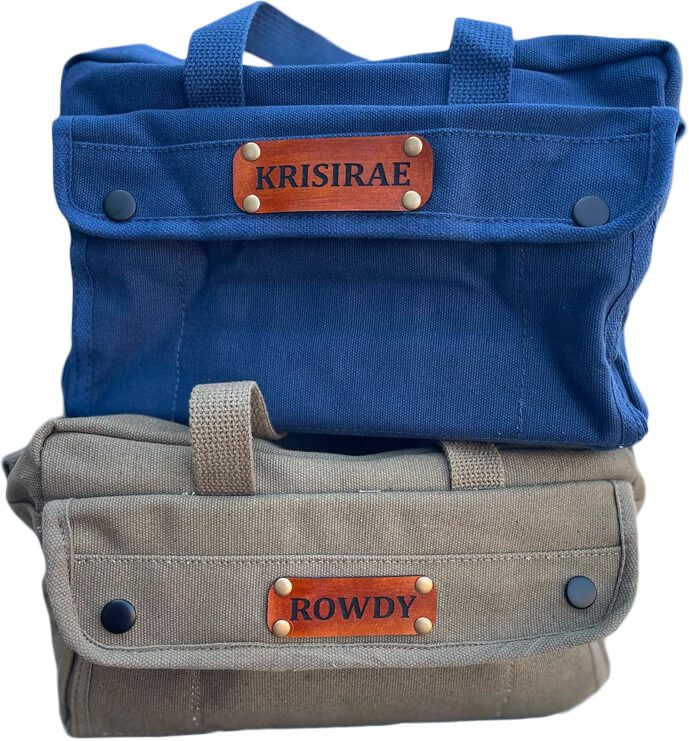 Two canvas bags, one blue labeled "KRISIRAE" and one khaki labeled "ROWDY."