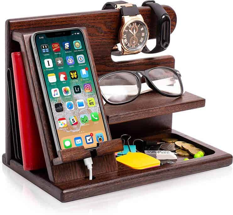 Wooden docking station organizer holding a phone, wallet, glasses, watch, and small items