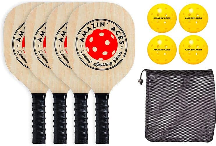 Pickleball set with four wooden paddles, four yellow balls, and a mesh carrying bag