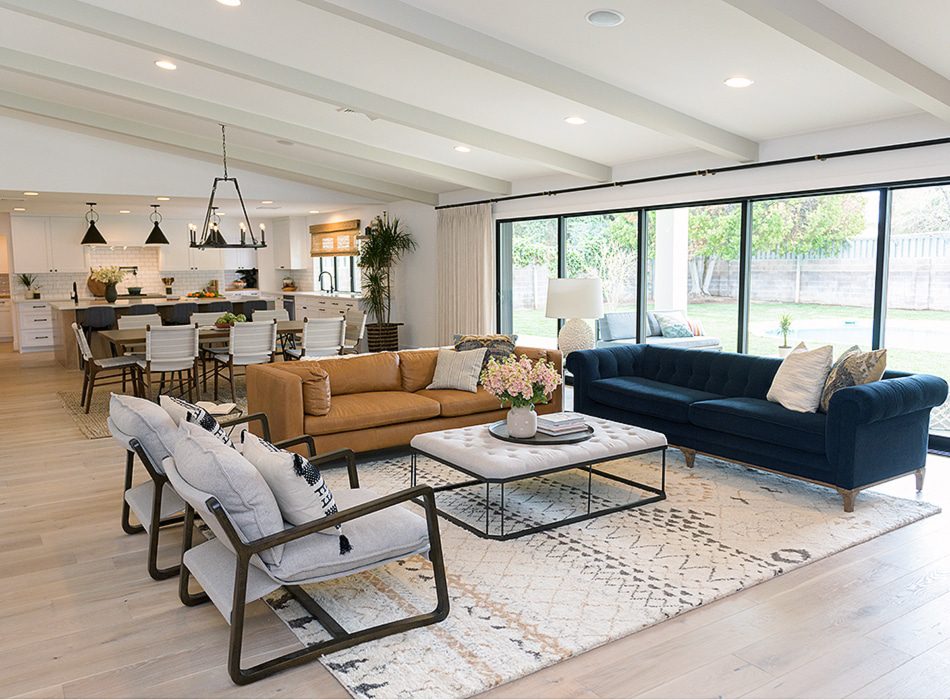Open living room with navy and tan sofas and glass doors