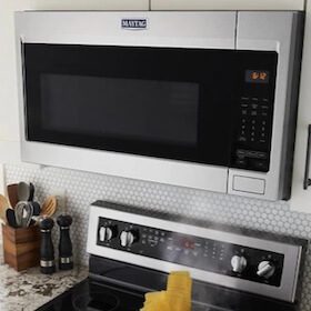 Microwave installed above stove in a compact kitchen setup