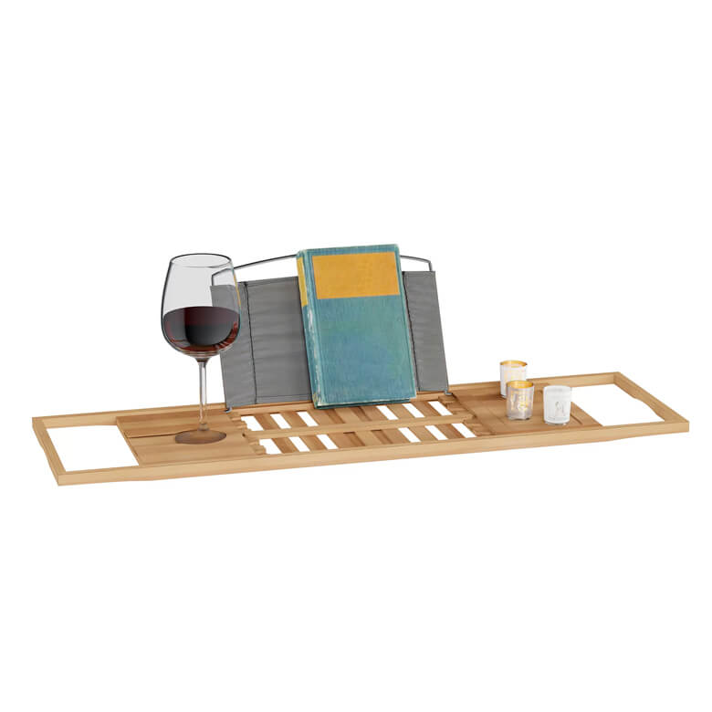 Bamboo bathtub tray holding a glass of wine, a book, and candles