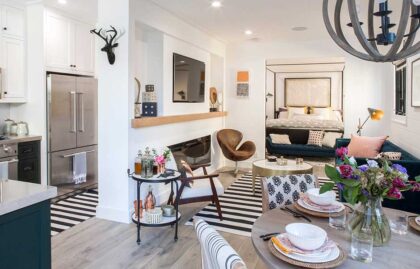 Bright open-concept space with kitchen, dining, and cozy bedroom nook