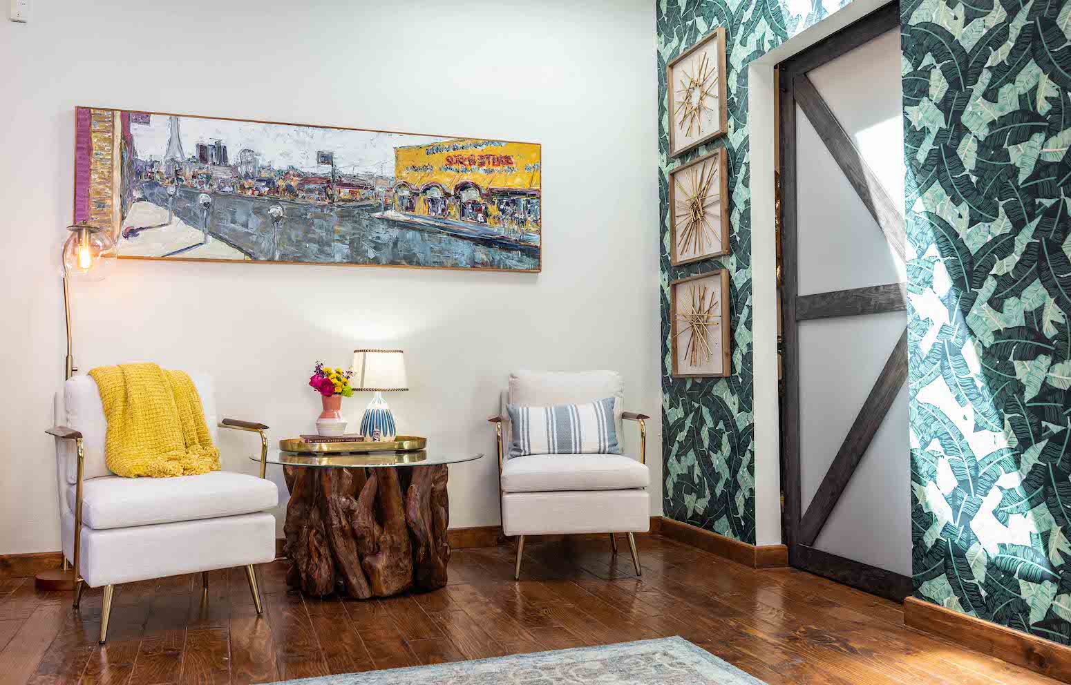 White chairs with wood table in a colorful, cozy corner