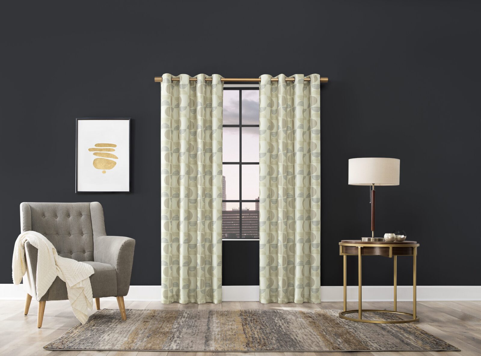 Stylish living space with patterned curtains, a gray armchair, a modern lamp, and a round side table