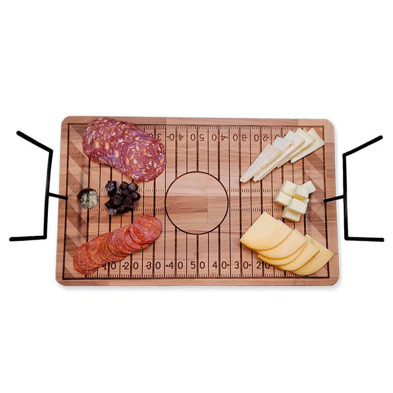 Football field-themed charcuterie board with assorted meats, cheeses, and olives