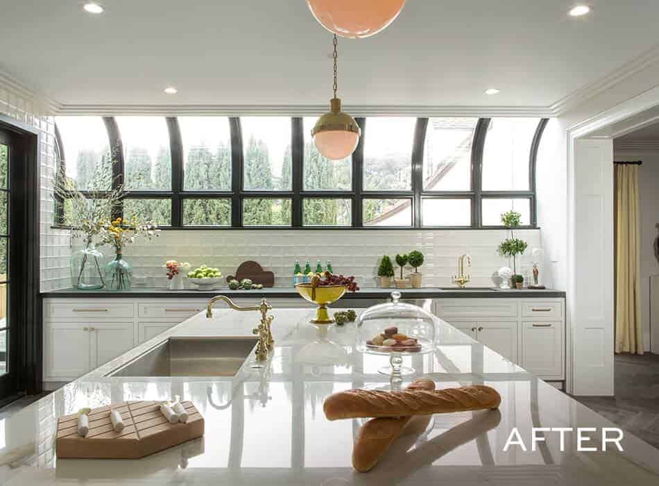Bright modern kitchen with large arched windows and white countertops