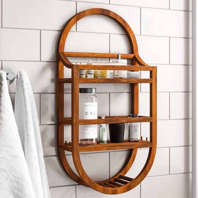 Wooden wall-mounted bathroom shelf with curved frame holding toiletries and decor items