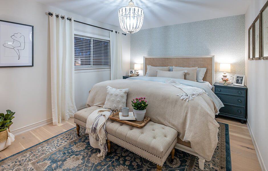 Modern bedroom with large bed, nightstands, lamps, and decor