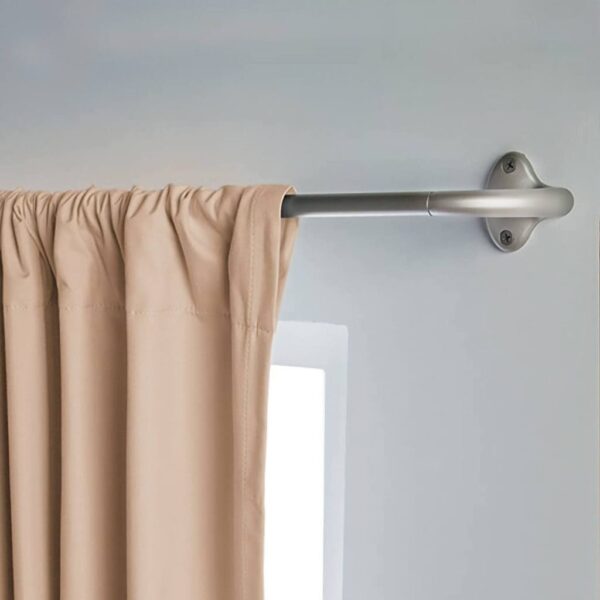 Beige curtain hanging on a silver wall-mounted rod