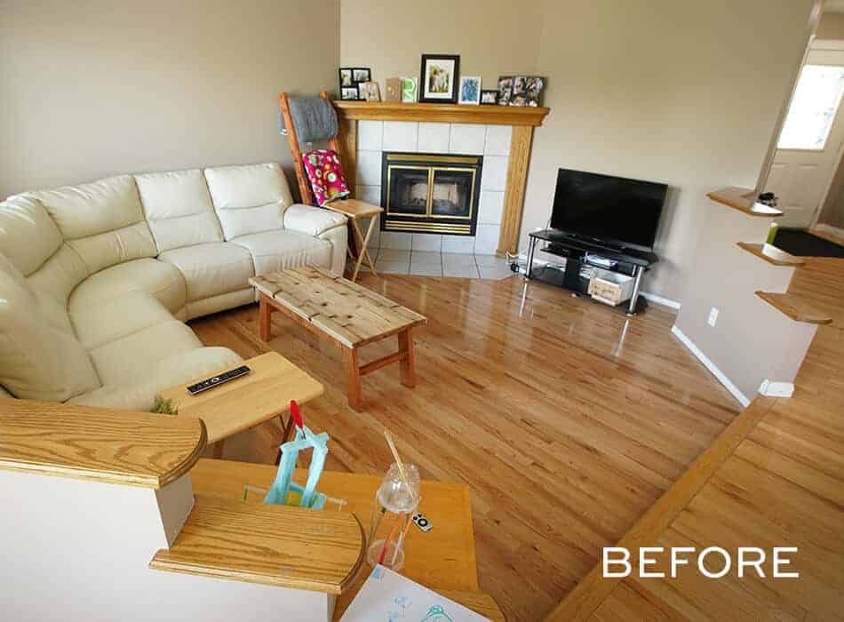 Living room with beige sectional sofa, wooden coffee table, fireplace, and TV on a stand