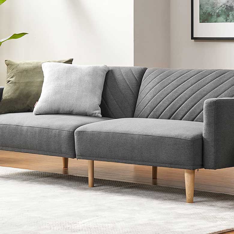 Gray fabric sofa with wooden legs, featuring a patterned design