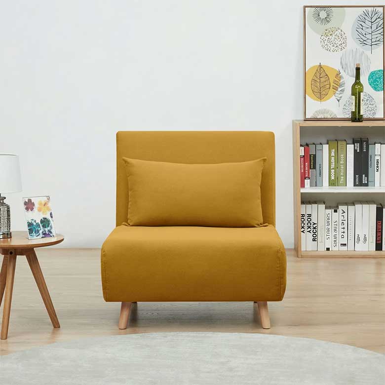 Mustard yellow accent chair with pillow in a minimalist reading nook
