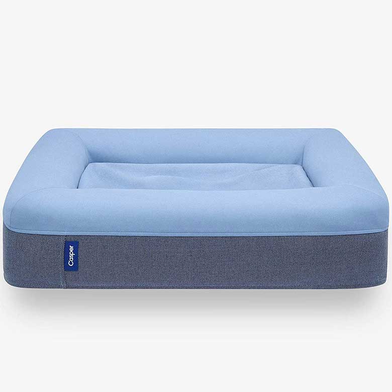 Blue rectangular pet bed with a raised border and a soft cushioned center