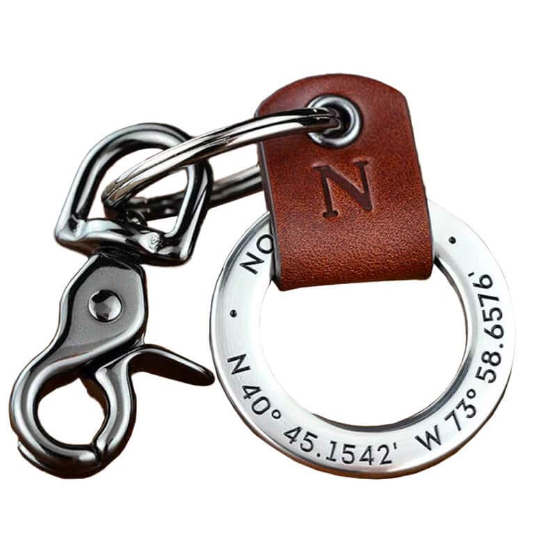 Metal keychain with leather strap, engraved with coordinates and the letter 