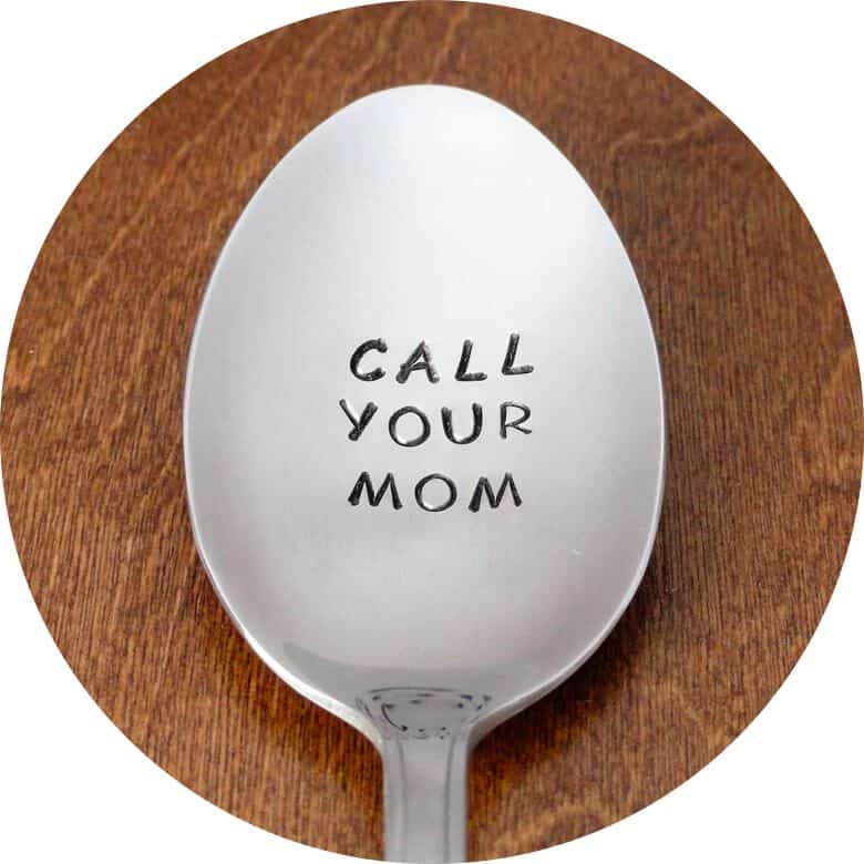 Metal spoon engraved with the phrase 