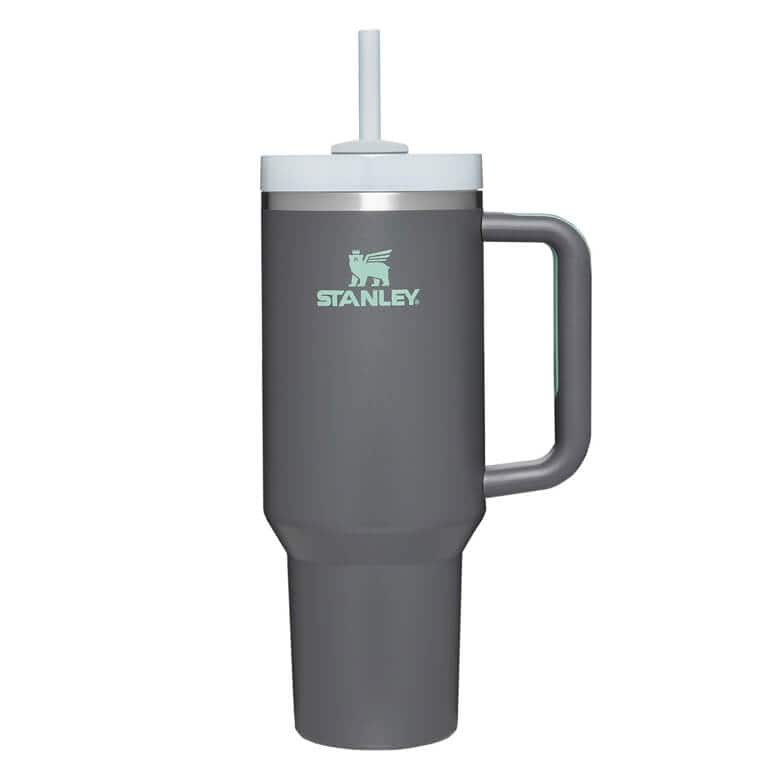 Gray Stanley travel tumbler with handle, white lid, and built-in straw