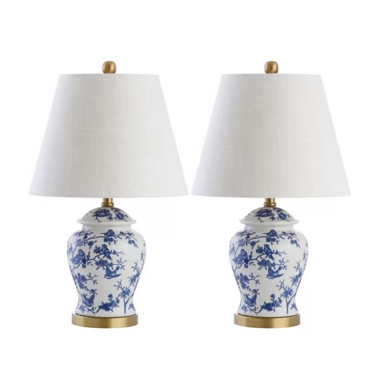 Pair of table lamps with white shades and blue floral ceramic bases on gold accents