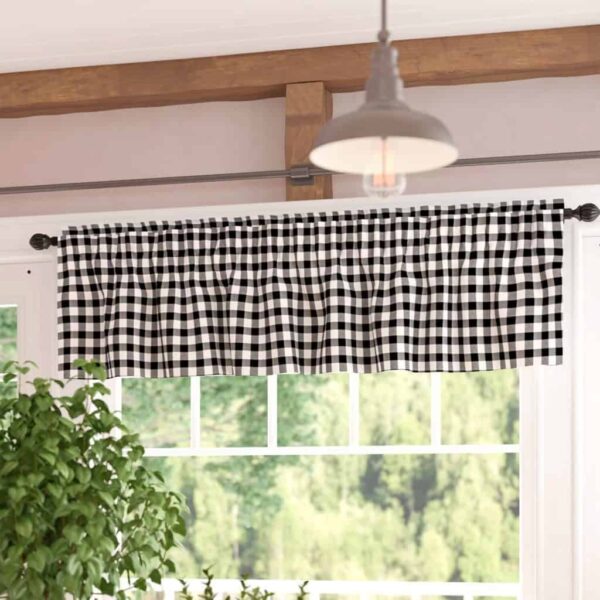 Black and white gingham valance over a window with a view of greenery