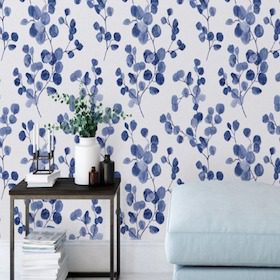 Table with vases against blue floral wallpaper