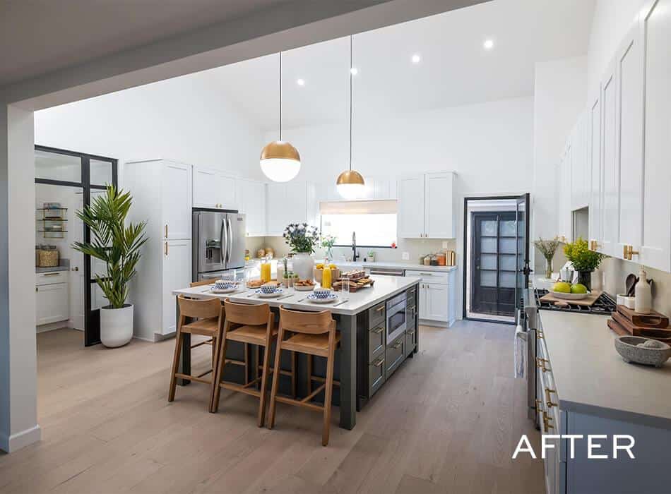 Bright kitchen with white cabinets, a central island, and stylish decor
