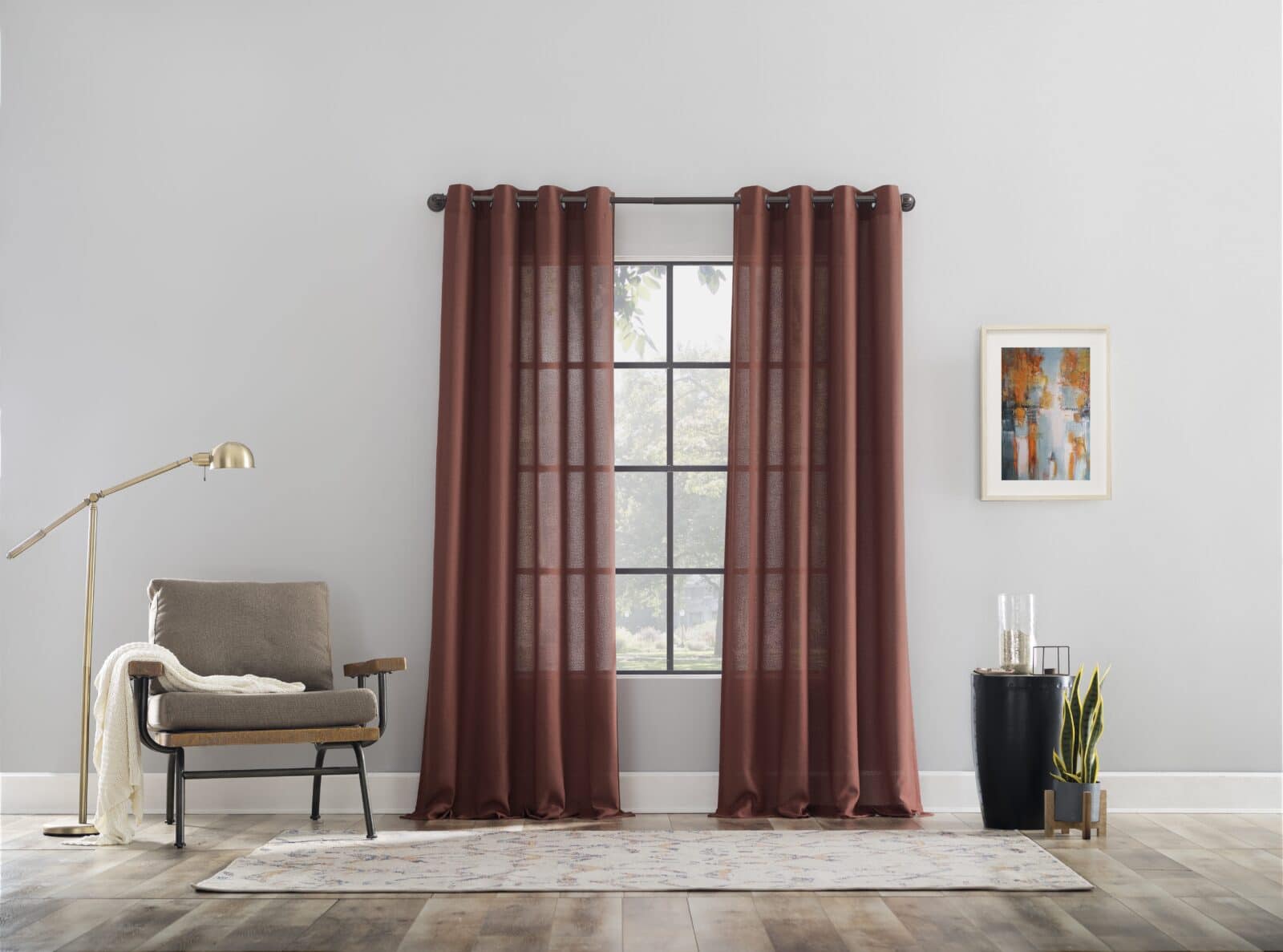 Modern living room with red curtains, armchair, floor lamp, and decorative accents