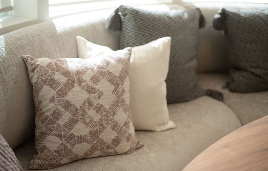Cozy seating area with decorative throw pillows in neutral tones
