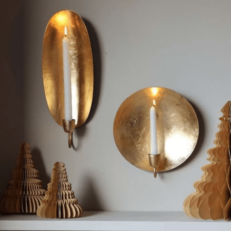 Decorative wall with lit candles and cone-shaped objects