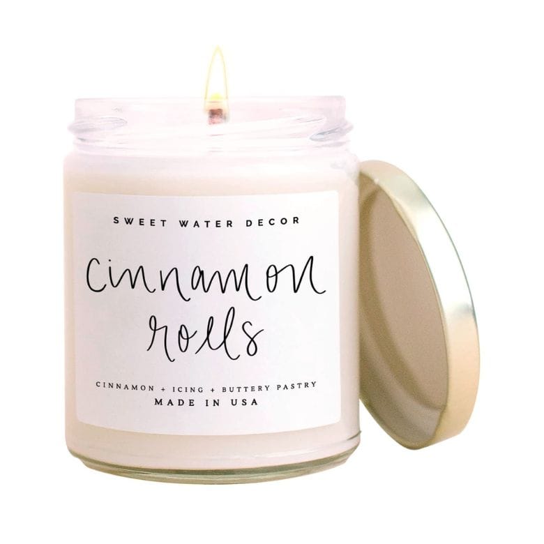 Lit cinnamon rolls scented jar candle with gold lid