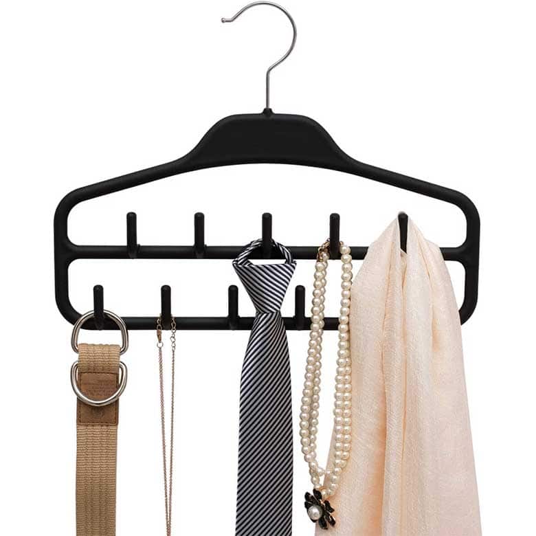 Black hanger organizer with multiple hooks holding a belt, necklace, tie, pearl necklace, and scarf