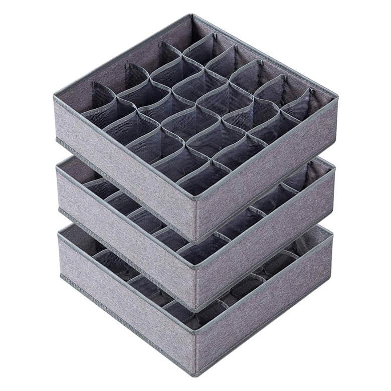 Stack of gray fabric drawer organizers with multiple compartments for storage