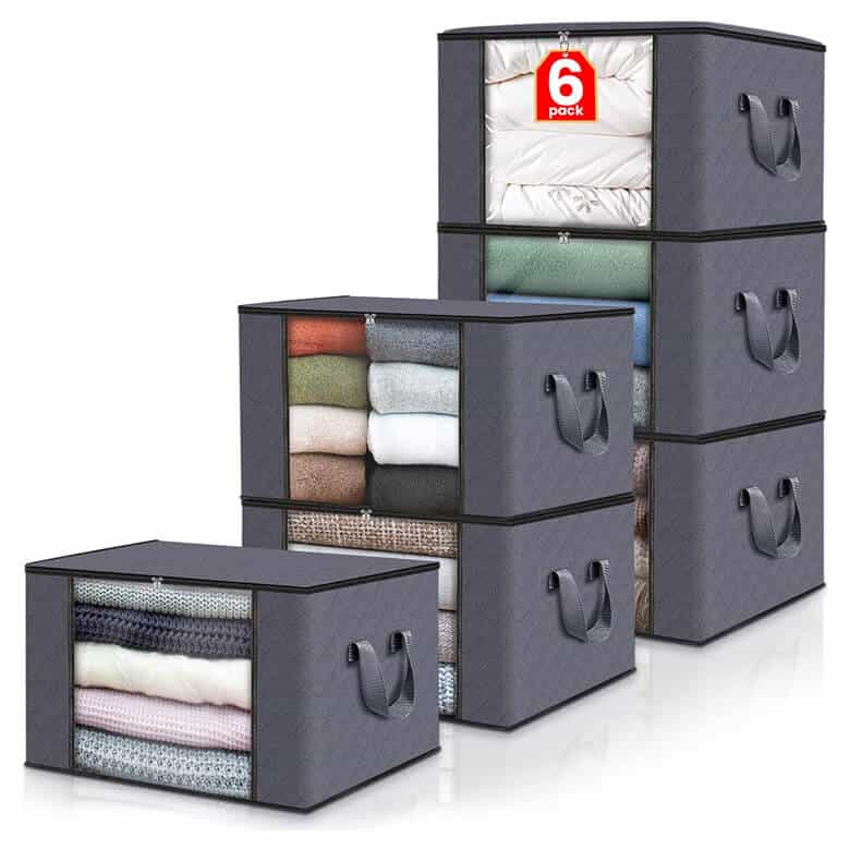 Gray fabric storage boxes with clear windows and side handles filled with clothes