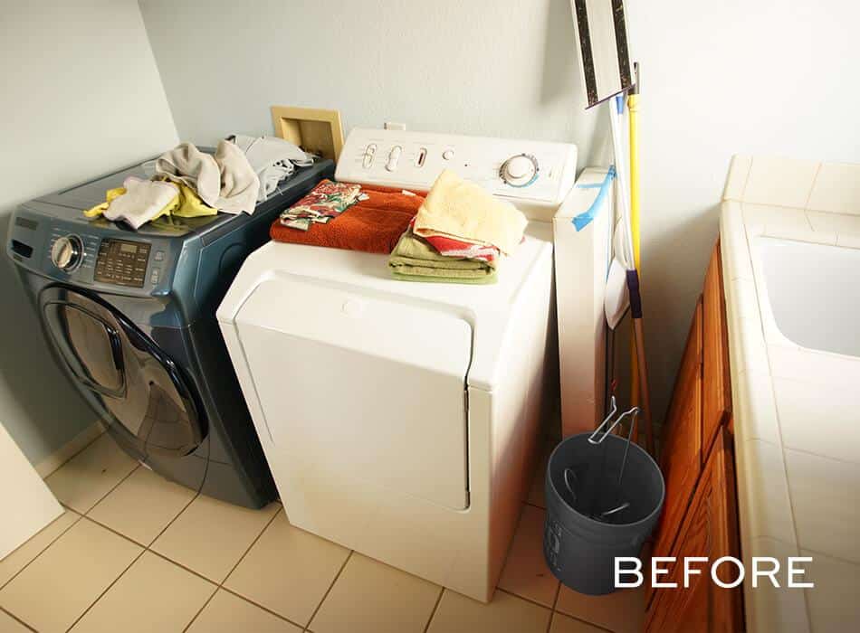 Cluttered laundry room with washer, dryer, and cleaning supplies